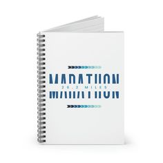 a spiral notebook with the words manhattan written in blue ink on it and an arrow