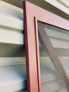 a close up of a window frame with blinds on the outside and side of it