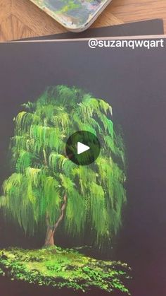 an image of a tree drawn with colored pencils on black paper and surrounded by other art supplies