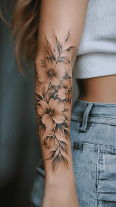 a woman's arm with flowers on it and the bottom half of her arm