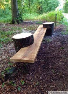 two wooden benches sitting in the middle of a forest