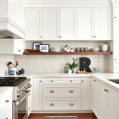 the kitchen is clean and ready for us to use it's white cabinetry