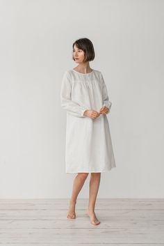 "MONA gather dress with long sleeves in milky white. - length is ± 107 cm (42\") (depends on size) - gathered front, back and sleeves - loose fit - without pockets DETAILS: - 100 % European, pre-washed medium weight linen (205 g/m²) - the model is 176 cm (5′9″) high, wearing size S. - model measurements: bust 83 cm (33\") / waist 61 cm (24\") / hips 90 cm (36\") - color in the picture - milky white (you can choose other color on the right) MADE TO ORDER: All pieces are made to order, it will tak White Long Sleeve Home Dress, White Long Sleeve Dress For Home, White Linen Loungewear Dress, Gather Dress, Linen Sleepwear, Gathered Dress, Dress Linen, Dress With Long Sleeves, Linen Dresses