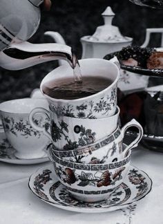 tea being poured into a cup with saucer