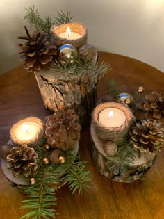 pine cones and candles are sitting on a table