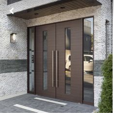 a modern entry with double doors and sidelights