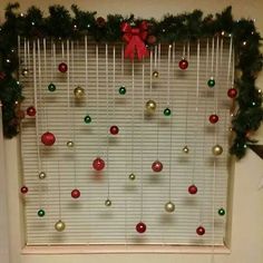 a window decorated with christmas ornaments and decorations