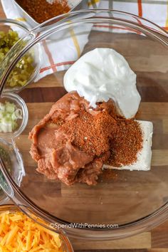 the ingredients to make an enchilada are displayed in bowls on a cutting board