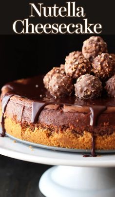 a chocolate cheesecake on a white cake plate with the words nutella cheesecake