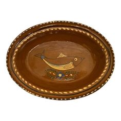 a brown bowl with fish painted on it