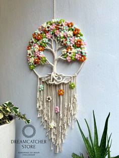 a wall hanging with a tree made out of beads