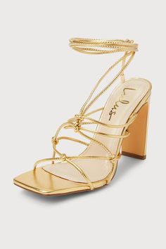 The Lulus Rinay Gold Strappy Lace-Up High Heel Sandals are exactly what your going-out 'fits have been missing! Shiny faux leather shapes these flirty heels that feature a trendy square footbed and single sole silhouette. Knotted ties create a strappy upper that houses long laces (with gold aglets) that wrap around and tie above the ankle. A sleek blade heel completes the look! 4" wrapped blade heel. Cushioned insole. Rubber sole has nonskid markings. Man made materials. Imported. Lulus | Rinay Gold Strappy Lace-Up High Heel Sandal Heels | Size 5. Heels For Long Dresses, Light Gold Heels, Gold Heels Prom, Gold Lace Up Heels, Homecoming Heels, Gold Sparkly Heels, Wrap Around Heels, Homecoming Freshman, Pretty Heels