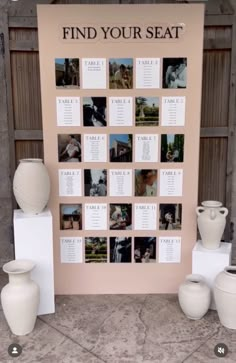 a table with vases and pictures on it in front of a sign that says find your seat