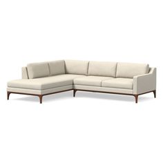 a white sectional couch sitting on top of a wooden frame