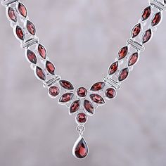 Dazzling the eyes with their sparkle, 17 carats of faceted garnet adorn this necklace from Alok Jain in India. The round, marquise, and pear-shaped gemstones are set in polished sterling silver and center a length of Cuban link chain. The elegant necklace is secured by a lobster claw clasp. Elegant Oval Garnet Necklace, Round Garnet Gemstone Necklaces, Elegant Drop Garnet Jewelry, Garnet Round Necklace In Fine Jewelry Style, Garnet Round Necklaces Fine Jewelry, Fine Jewelry Marquise Gemstone Necklace, Exquisite Marquise Necklaces For Gifts, Exquisite Marquise Necklace For Gift, Elegant Garnet Necklace For Formal Occasions