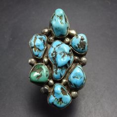 VINTAGE STERLING SILVER  TURQUOISE CLUSTER RING DESCRIPTION:  With 7 gorgeous cabs of natural blue turquoise and a heavy gauge split shank band, this ring will be a cherished addition to your collection of quality vintage Southwestern and Native American jewelry. MEASUREMENTS:  Ring face measures 1 1/2" x 1" RING SIZE: 7 1/2 WEIGHT: 15.2 grams SIGNED:  no STERLING:  unmarked, verified sterling silver Native American Rings, Cowgirl Jewelry, Split Shank, Ring Pictures, Vintage Turquoise, Native American Jewelry, Cluster Ring, Emerald Ring, Turquoise Sterling Silver