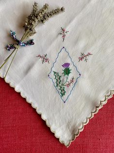 an embroidered cloth with flowers on it