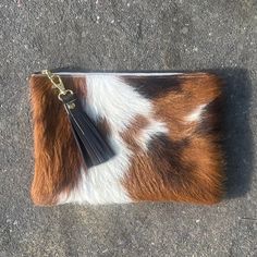 This is a beautiful Breccia clutch bag that is great for so many occasions, or for use everyday with style. Dimensions: Height: 18.5cm (7.3in) Width: 24cm (9.4in) Flat construction. The Breccia clutch is made from hair on cowhide in tricolour brown, black and white (sometimes with creamy yellow patches) with soft, brown leather on the back. Please choose from the drop down list should you want cowhide on both sides. The Breccia has a cotton, fawn lining with gold dots and a handy credit card siz Brown Handheld Clutch As Gift, Brown Handheld Clutch As A Gift, Brown Pouch Clutch, Brown Pouch Clutch As Gift, Brown Clutch With Zipper Pouch As Gift, White Clutch Purse, Cowhide Clutch, White Clutch, Leather Clutch Bag