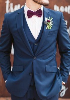 a man wearing a blue suit and bow tie