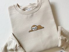 Embroidered Sloth Sweatshirt, Embroidered Sloth Shirt, Sleeping Sloth Shirt, Funny Sloth Shirt, Coffee Sloth Hoodie, Lazy Sloth Lover Gift This Cute Embroidered Sloth Sweatshirt is a must-have for your all season wardrobe! Whether you're running errands, going for a walk, attending a concert/party, or staying cozy at home, this unisex sweatshirt is perfect for you! Our crewnecks are made from the highest quality fabric for an incredibly soft and comfortable fit, with advanced printing to ensure that the colors and graphics are vibrant and detailed. ❤ The price is for ONE item only. If you want to order matching shirts, add each item separately by choosing different colors and sizes each time, and add each one into your cart. ❤ This unisex sweater is intended to be oversized and loose-fitti Concert Party, Cozy At Home, Sloth Shirt, Funny Sloth, Sloth Lovers, Sloths Funny, Matching Sweaters, Animal Sweatshirt, Easy Trendy Outfits