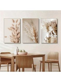 three paintings hanging on the wall above a dining room table with chairs and vases