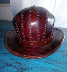 Handmade leather Bowler hat..Hand dyed and stitched stitched... It was dyed  with a mahogany brown finish... It is lined with a pigskin lining... Very durable and stylish...  measures 22 inches around inside . ....This hat has my Lizard Leather logo / makers mark stamped into it and was made in Berry, Alabama USA ...actual hat may differ in exact coloring of leather tone and  hardware from the one pictured.. All sales are FINAL...NO REFUNDS OR CANCELATIONS will be made...So be certain you want it before pressing the buy button.Only sold and  shipped in the lower 48 states.... No returns Mahogany Brown, Bowler Hat, Hat Handmade, Pig Skin, Leather Logo, Logo Maker, Handmade Leather, Makers Mark, Leather Handmade