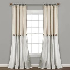 a window with white curtains hanging on the side and a brown curtain rod in front