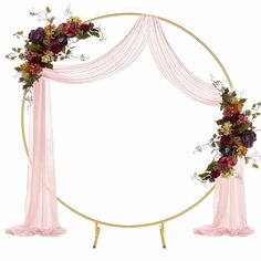 a pink and gold wedding arch with flowers