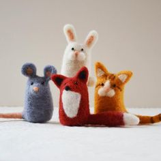 four small stuffed animals sitting next to each other