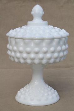 a white ceramic covered dish on a table