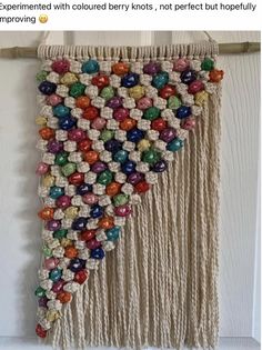 a wall hanging made out of macrame beads