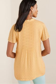 A swingy, flowing top with pleats down the front and back neckline. The shirt has short sleeves and is fully lined. Casual Pintuck Short Sleeve Tops, Casual Short Sleeve Tops With Pintucks, Casual Pleated Short Sleeve Blouse, Casual Short Sleeve Pleated Blouse, Short Sleeve Pleated Blouse For Spring, Pleated Short Sleeve Blouse For Spring, Spring Pleated Short Sleeve Blouse, Summer Pintuck Short Sleeve Tops, Chic Short Sleeve Blouse With Crinkle Texture