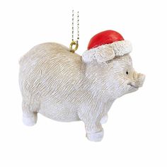 a white ceramic pig ornament with a santa hat on it's head