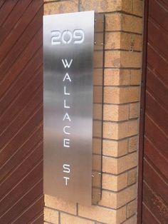 a metal sign on the side of a brick building that says walge street in english