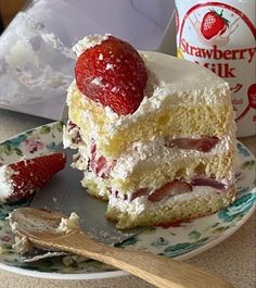 a piece of cake on a plate with strawberries