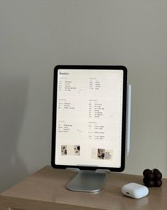 a computer monitor sitting on top of a wooden desk next to a keyboard and mouse