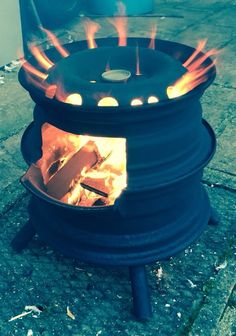 an open fire pit sitting on top of a sidewalk