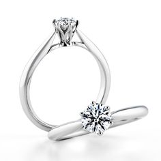 a white gold engagement ring with a single diamond in the center, on a white background