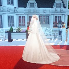 a woman in a wedding dress standing on a red carpet with a large white building behind her