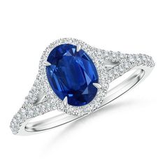 an oval blue sapphire and diamond ring on a white background with diamonds around the band