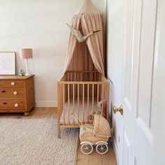 a baby's room with a crib and dresser