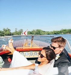 the bride and groom are riding in a boat