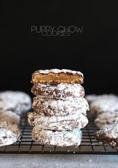 powdered sugar covered doughnuts stacked on top of each other in front of a black background