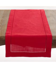 a red table runner on top of a wooden table