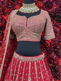 Go all out in this whimsical lehenga, studded with precious mirror, pearl, stone, embroidery work, which is sure to bring out the innate grace and grandeur in you! Color - Crimson Red Fabric & Work Style - - Silk blouse: mirror, pearl, stone, embroidery work. - Soft net lehenga: mirror, pearl, stone, embroidery work. - Soft net dupatta: embroidery work. Details - - Assured quality - Wash care instruction: Dry clean only. - Slight variation in color is possible due to digital photography. Red Embellished Sharara For Navratri, Elegant Red Anarkali Set With Dori Work, Semi-stitched Red Sets With Mirror Work, Red Embellished Georgette Dupatta, Red Chinon Sets With Mirror Work, Red Embellished Georgette Anarkali Set, Festive Kundan Lehenga With Zari Work, Navratri Embellished Traditional Wear With Traditional Drape, Embellished Kundan Sets For Reception