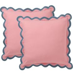 two pink pillows with scalloped edges and blue piping on the bottom one