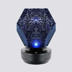 an image of a blue light that is on top of a speaker with stars all over it