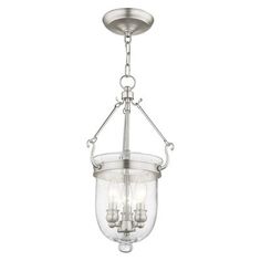 a light fixture with three lights hanging from it's ceiling, and the glass is clear