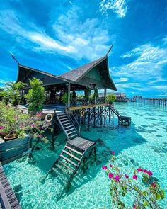 the water is crystal blue and clear with some chairs on it in front of a dock