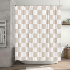 a bathroom with a checkered shower curtain next to a bathtub and towel rack